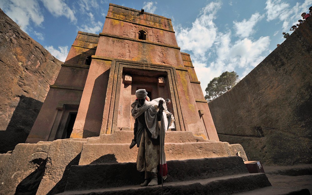 An Ethiopian Orthodox Christian pilgrim leaves the rock-hewn church Bete Giyorgis after attending a mass before the annual festival of Timkat in Lalibela, Ethiopia which celebrates the Baptism of Jesus in the Jordan River, on January 19, 2012. During Timkat, the Tabot, a model of the Ark of the Covenant is taken out of every Ethiopian church for 24 hours and paraded during a procession in towns across the country. Over 80 % of Ethiopians are estimated to be Orthodox Christians. Ethiopian Orthodox Christians believe the real Ark of the Covenant ( a vessel containing the Ten Commandments)  is held in Aksum. It is guarded by a select group of monks, whose sole commitment is to protect the sacred vessel. AFP PHOTO/CARL DE SOUZA